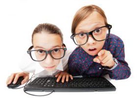 Young girls playing or working on a computer